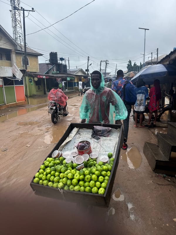 Street vendor sells green produce from wooden cart in Ihiagwa