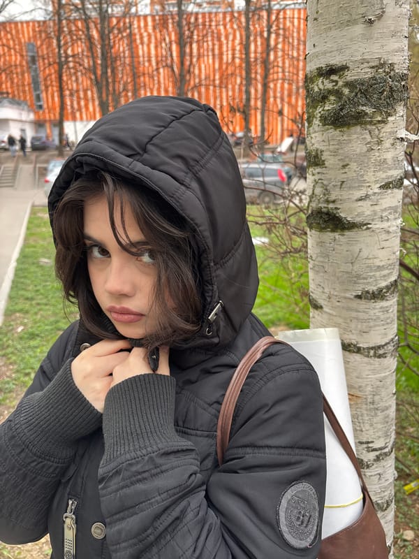 Young woman photographed in black jacket, central Moscow