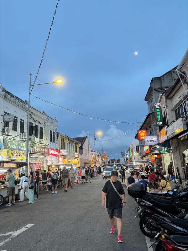 Southeast Asian street scene comes alive at dusk with food and traffic