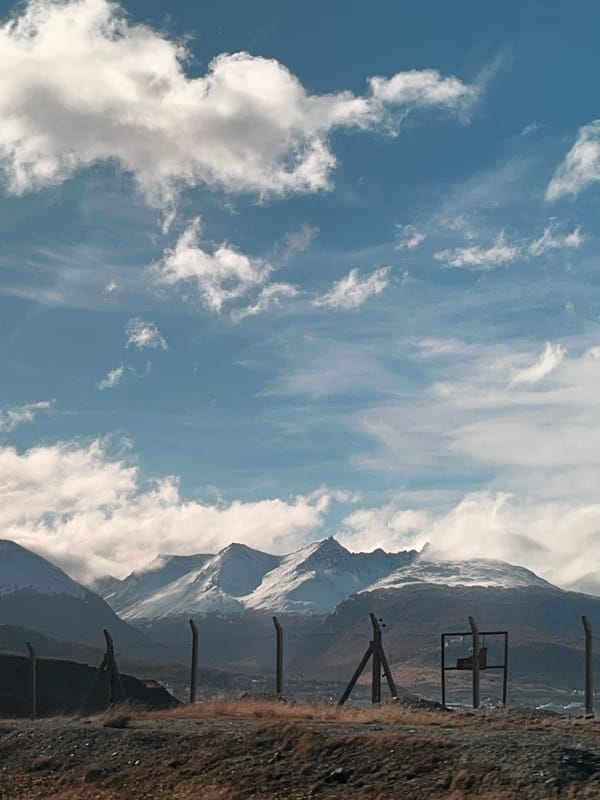 Snow-capped mountains observed under cloudy skies in Ushuaia