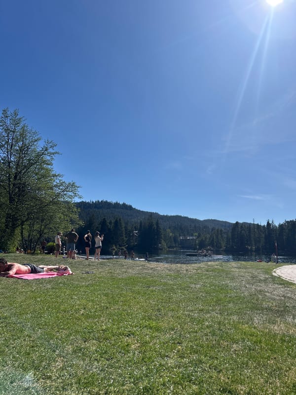 Group gathers at Whistler lake during late evening sunshine