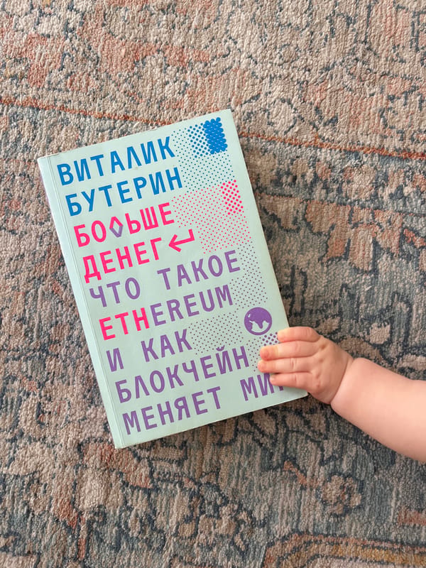 Limassol resident examines Russian Ethereum book with baby present