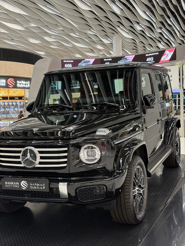 Luxury car display, modern interiors documented at Bahrain airport