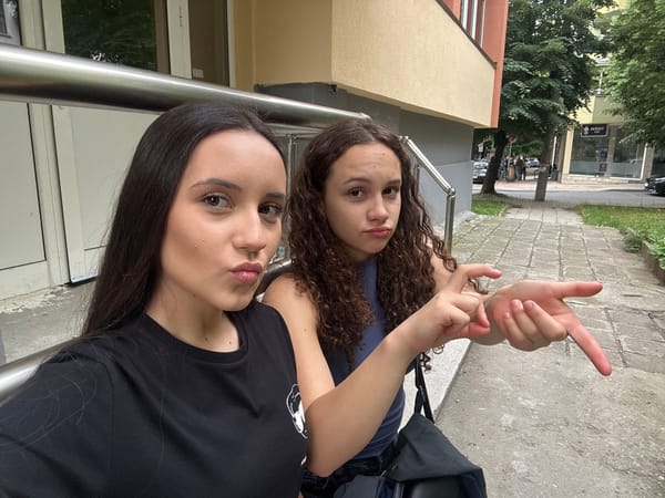 Selfies and candid moments outside near a black station wagon