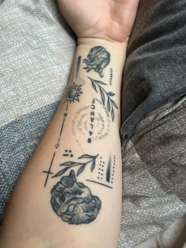 Tattoo, sleepy cat, and a miniature cart — a quiet evening in.