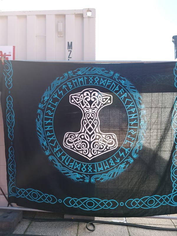 Outdoor art display features mythology banners and classical sculptures