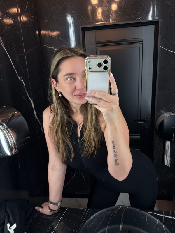 Woman takes bathroom selfies in black marble Moscow restroom