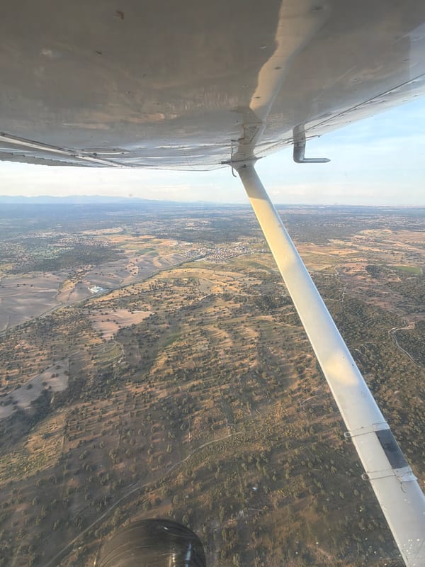 Aircraft flies over Villamantilla countryside in evening flight