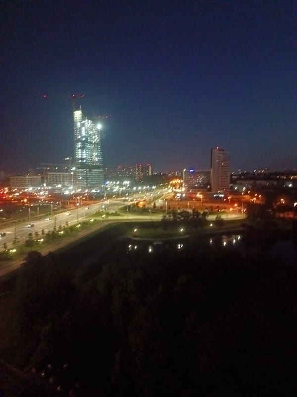 Minsk skyscraper under construction glows against the night sky