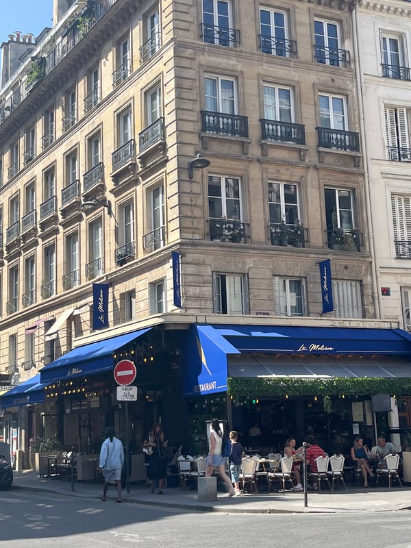 Blue-awninged café terrace on a Paris street