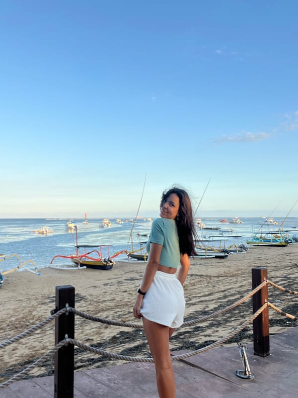 Woman poses for photos on Denpasar beach