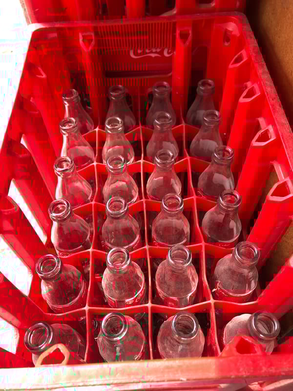 Empty Coke bottles in red crate observed in Casablanca