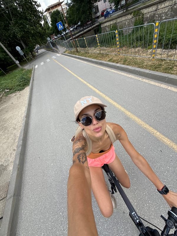 Woman cycles through Pleven wearing colorful summer clothing