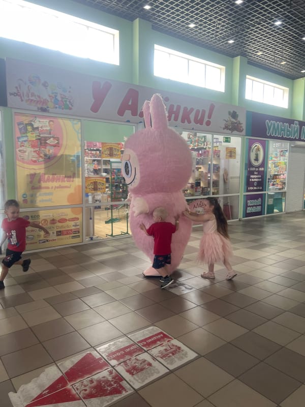 Pink bunny mascot meets the mall crowd at a beauty store