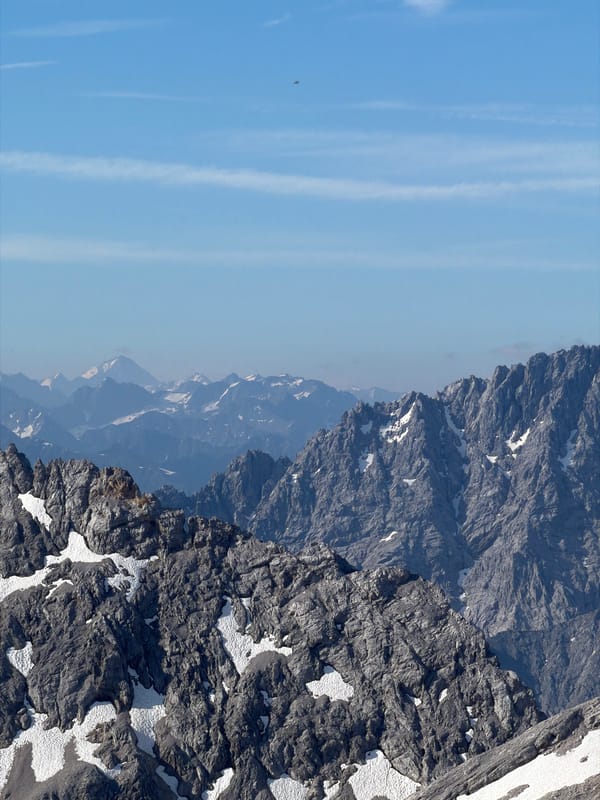 Coffee and snow groomers at a Garmisch mountain summit