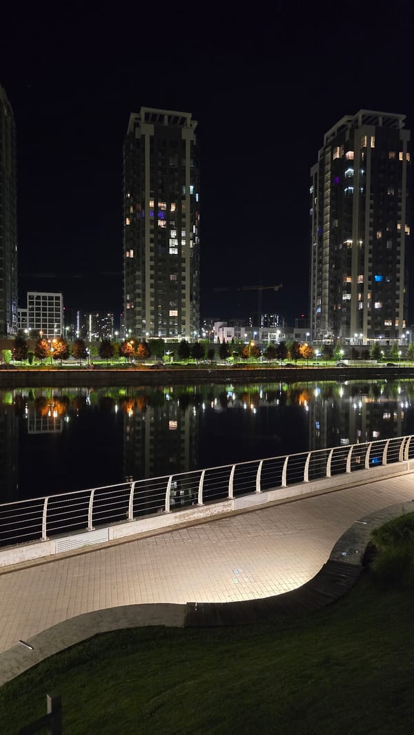 Evening stroll documented across illuminated Kyiv waterfront and parks