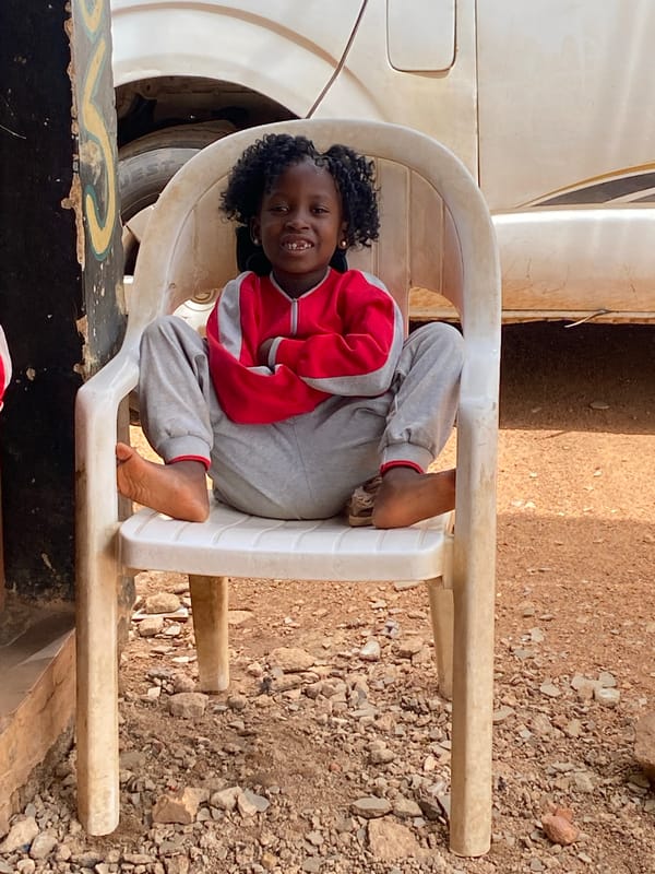 Children rest in plastic chairs in Kuru, Nigeria