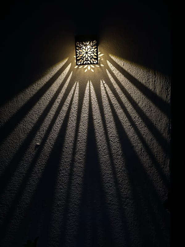 Ornate lantern casts starburst shadows at Villa Pasquali