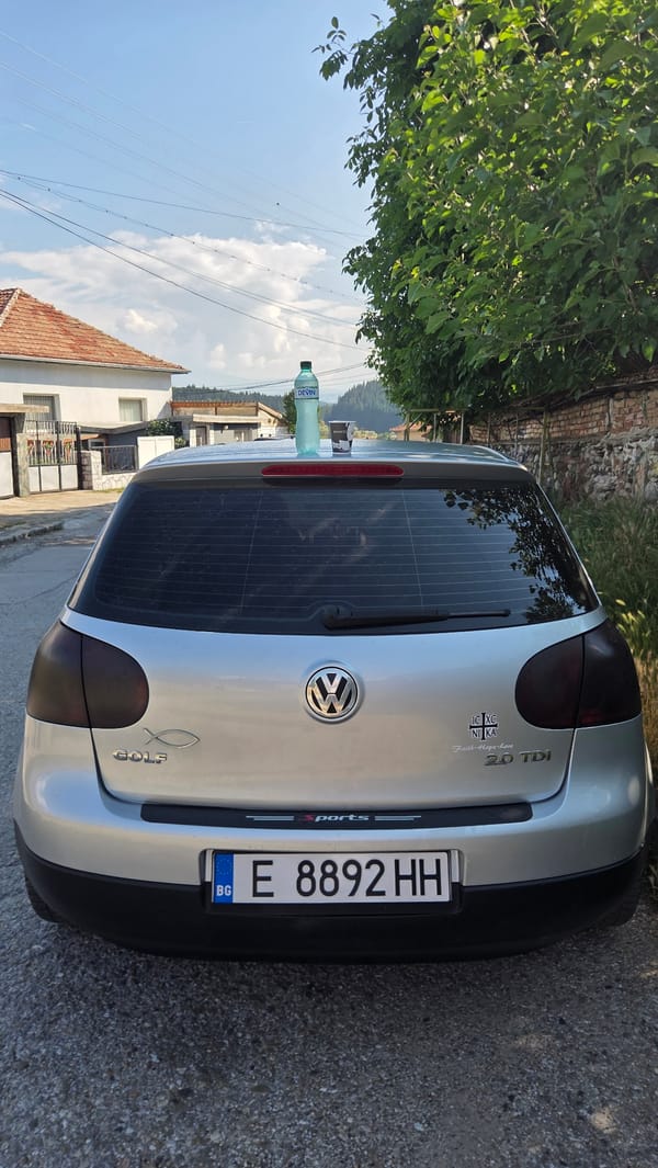 Silver VW Golf parked on a Bulgarian town street, morning