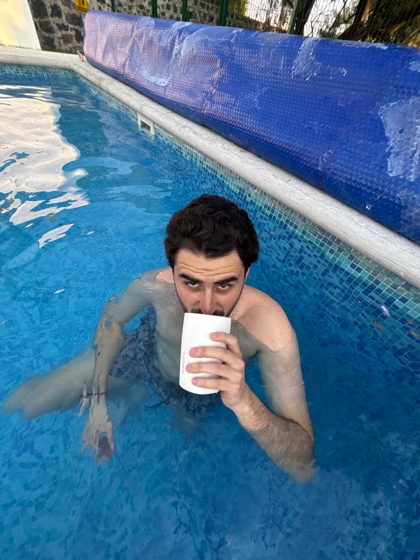 Man drinks from container while swimming in Mexico pool
