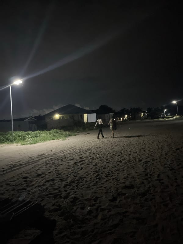 Two people spotted on urban beach during cloudy evening