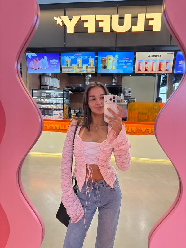 Woman takes mirror selfie at Krasnoyarsk cafe