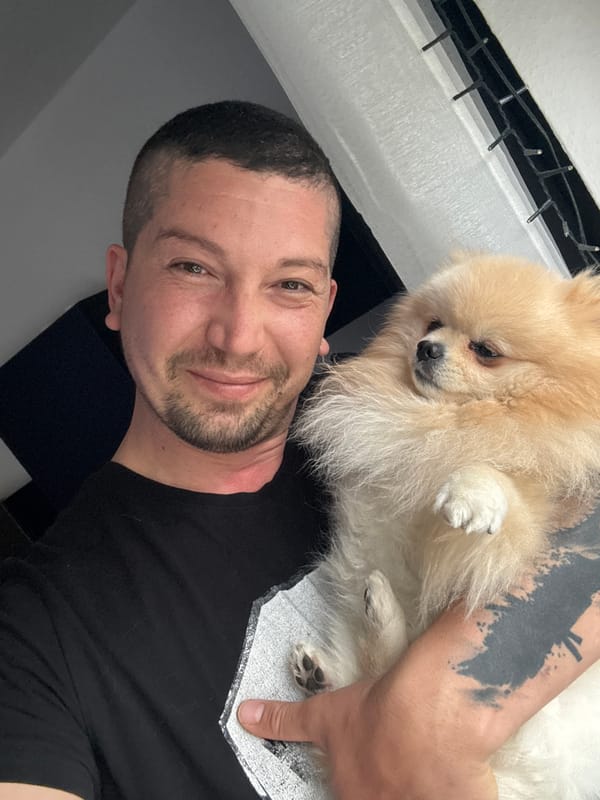 Man poses with Pomeranian dog in German town