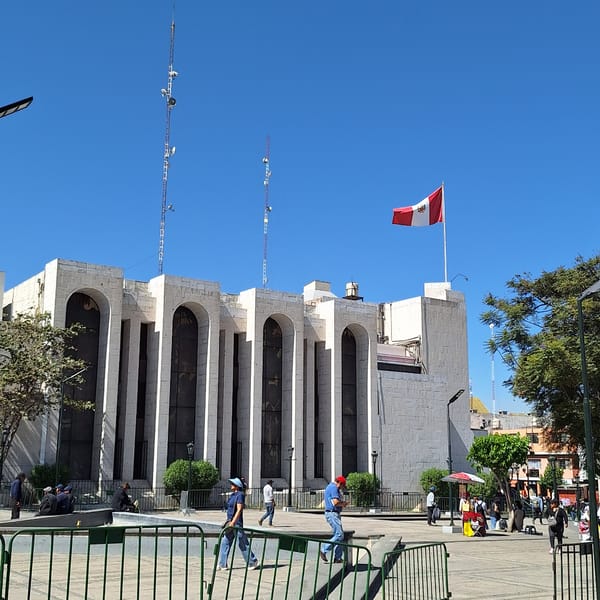 Stone building with Peruvian flag observed in Arequipa