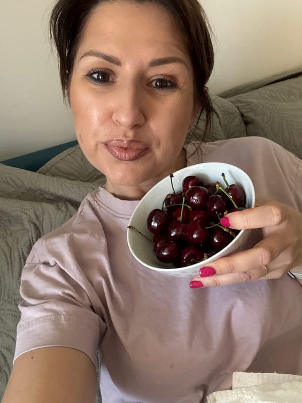 Woman enjoys fresh cherries indoors in Sofia