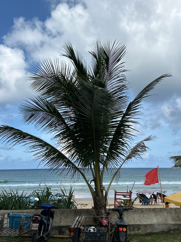 Karon Beach on a cloudy afternoon, surf gear and street life