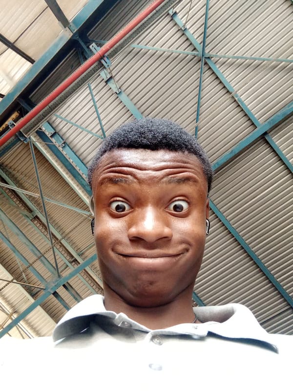 Young man takes playful photos in Nigerian warehouse facility