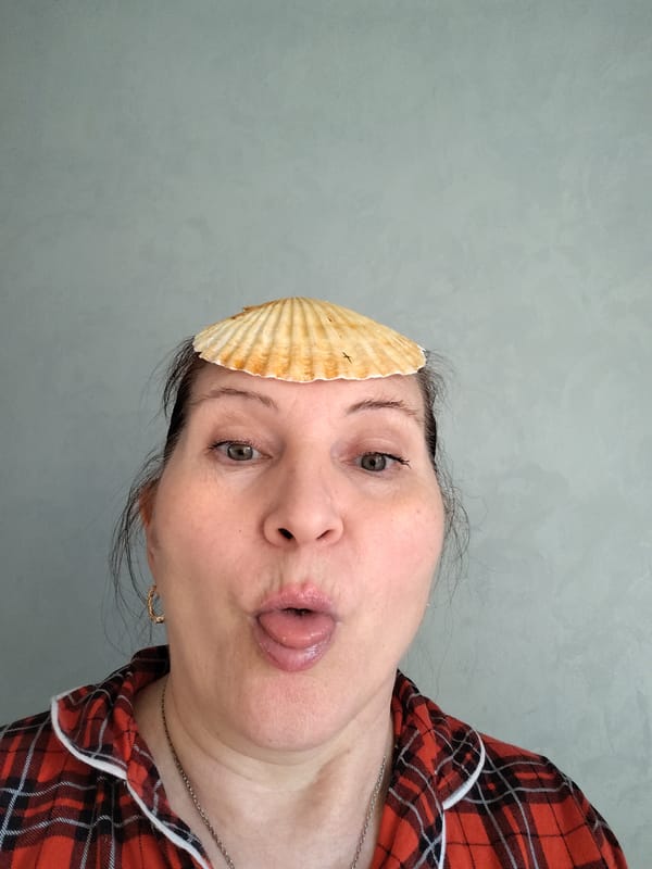 Woman playfully balances scallop shell on forehead in Russia
