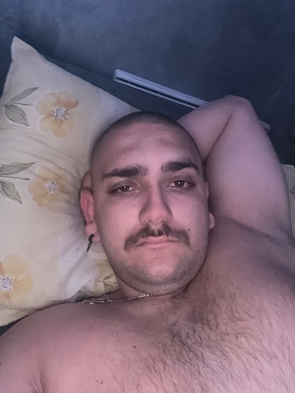 Man relaxes with laptop on sofa in Pernik