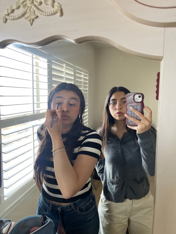 Women share mirror moment during makeup routine in San Antonio