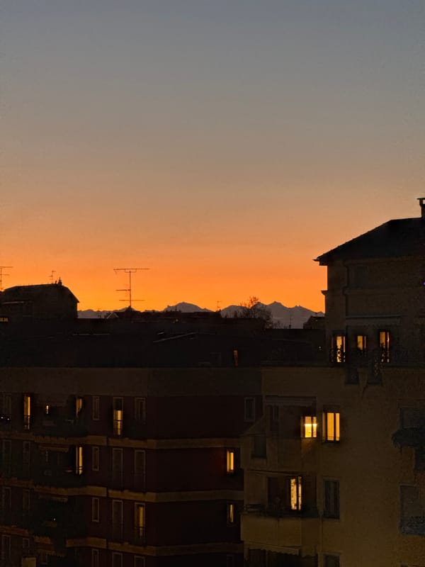 Milan skyline captured at twilight with orange horizon gradient
