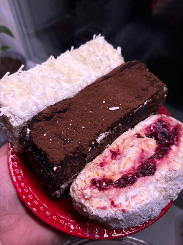 Three decorated cake slices photographed on red plate in Russia