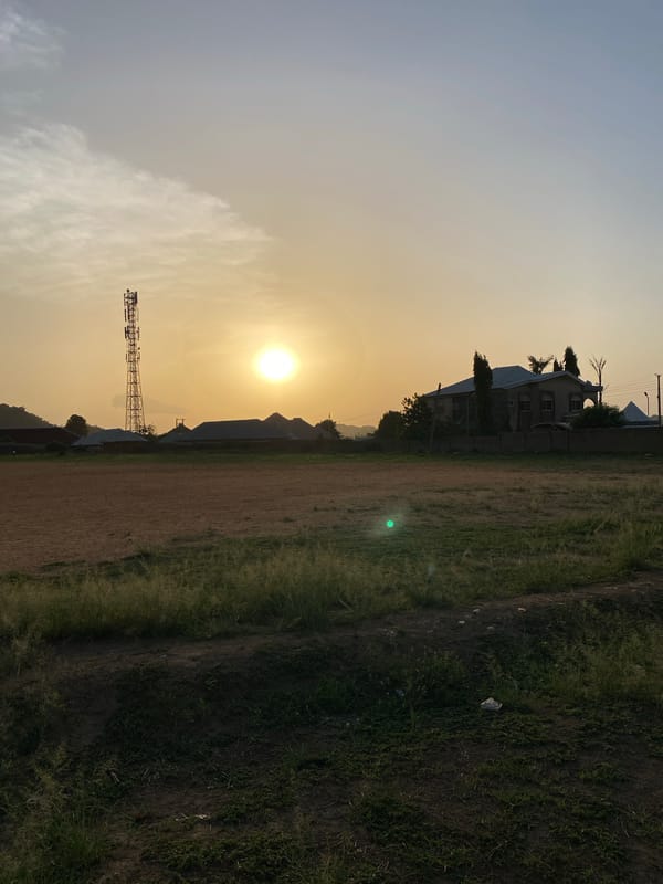 Casual soccer game documented on dirt field in Bukuru, Nigeria