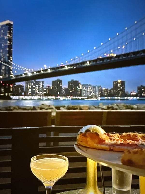 Pizza and cocktails with a nighttime Pori waterfront view