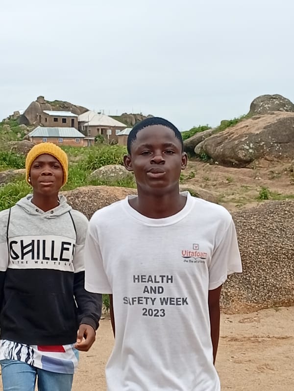 Football and friends at a rocky outdoor pitch in Jos