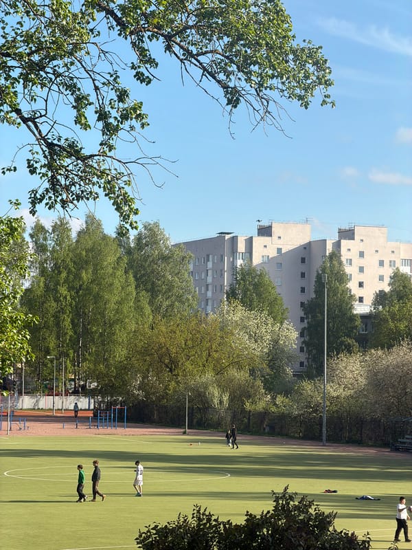 Children play on sports field in Russian residential district