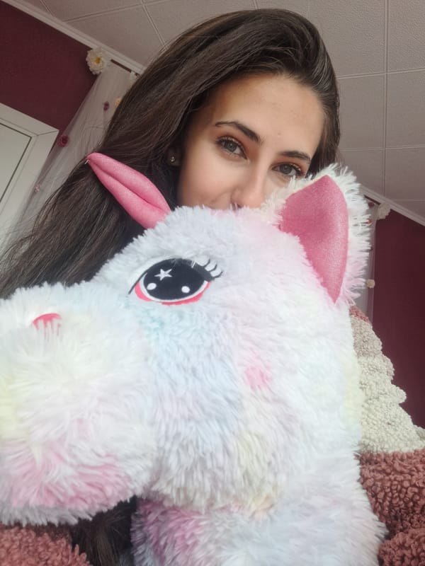 Woman holds stuffed unicorn in Bulgarian home