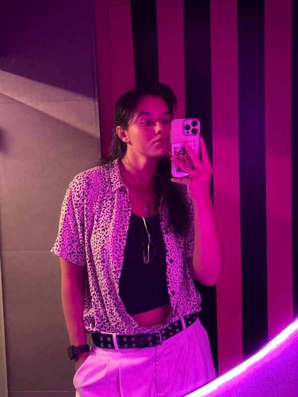 Mirror selfie captured with purple neon lighting in Arpora