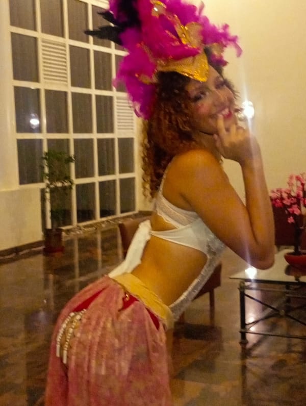 Carnival performers pose in elaborate costumes in Venezuelan hotel