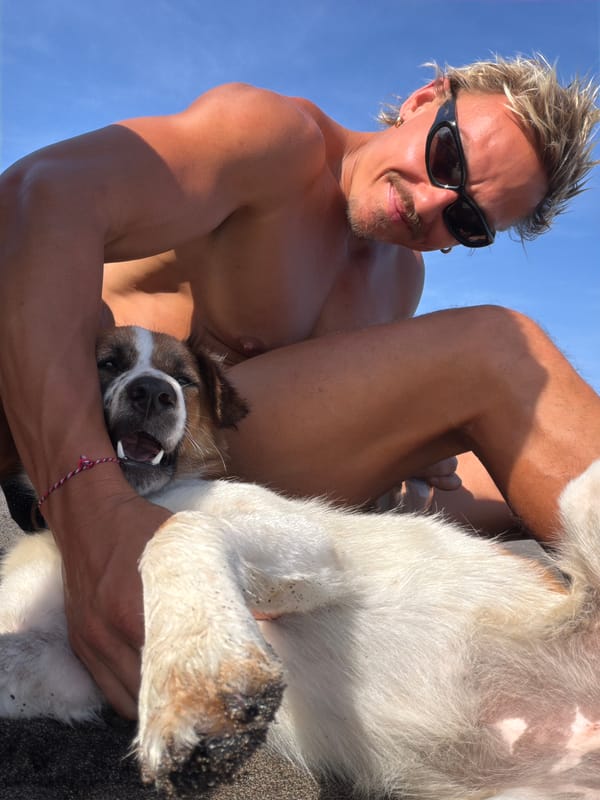 Man and dog enjoy morning beach time in Mengwi
