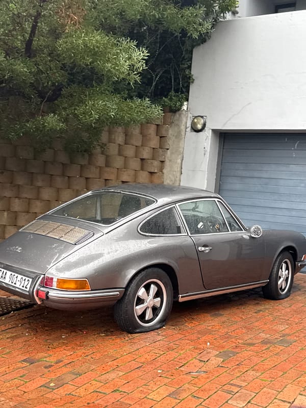 Gray Porsche 911 photographed on brick driveway in Cape Town