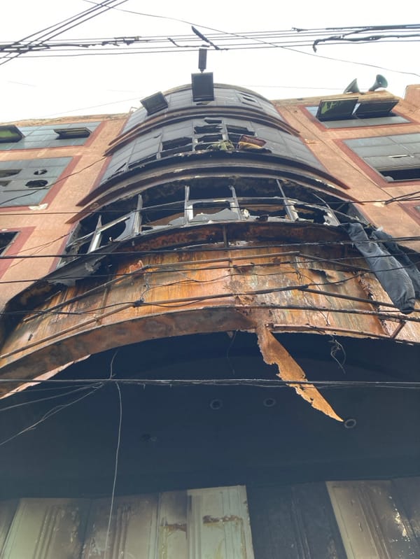 Fire-damaged building documented in Quetta amid daily street life