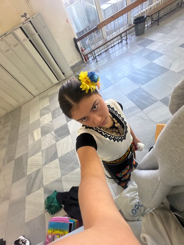 Woman photographed wearing traditional folk costume in school setting