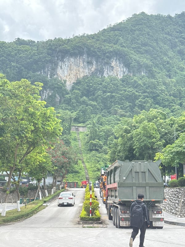 Semi-trucks parked near mountainous road in Đồng Đăng, Vietnam