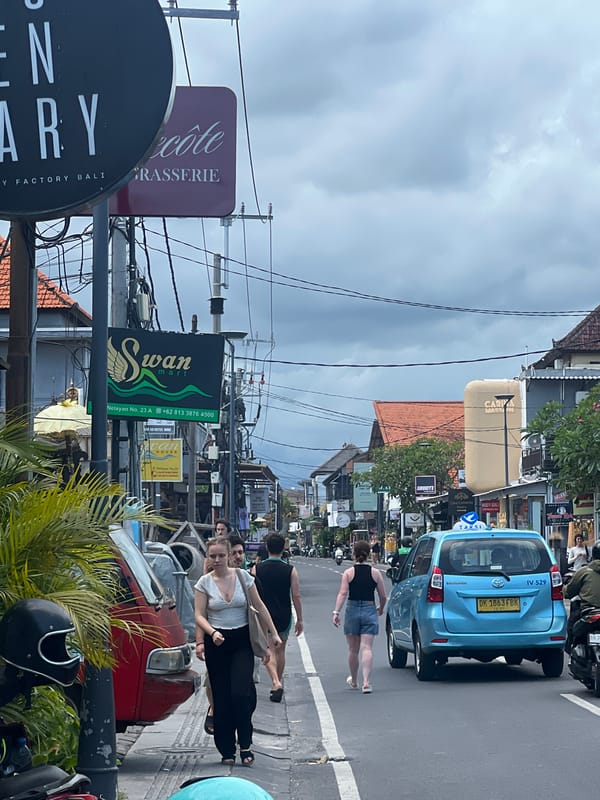 Taxi and pedestrians captured on Canggu street scene