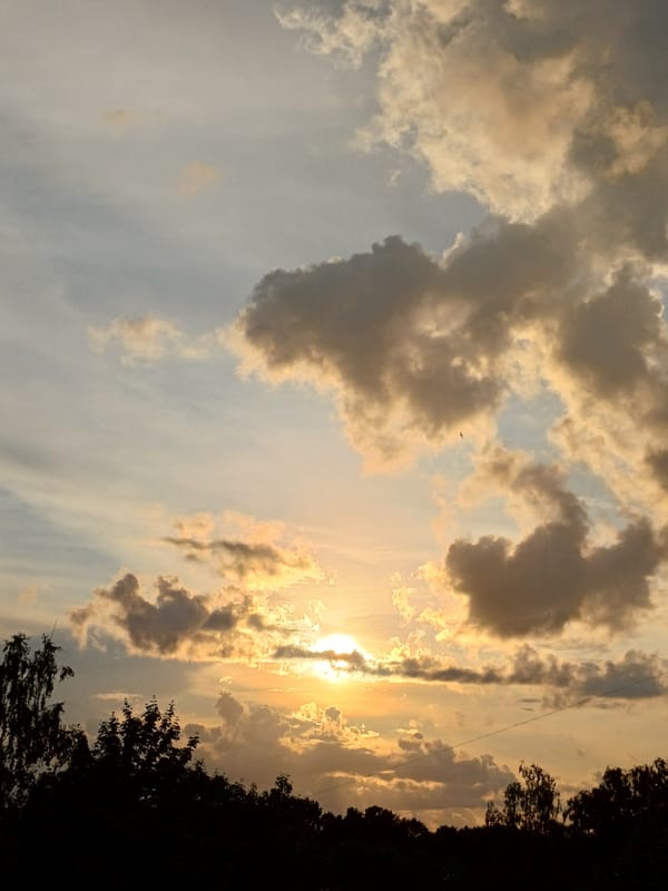 Dramatic cloud-broken sunset over Riga's outskirts